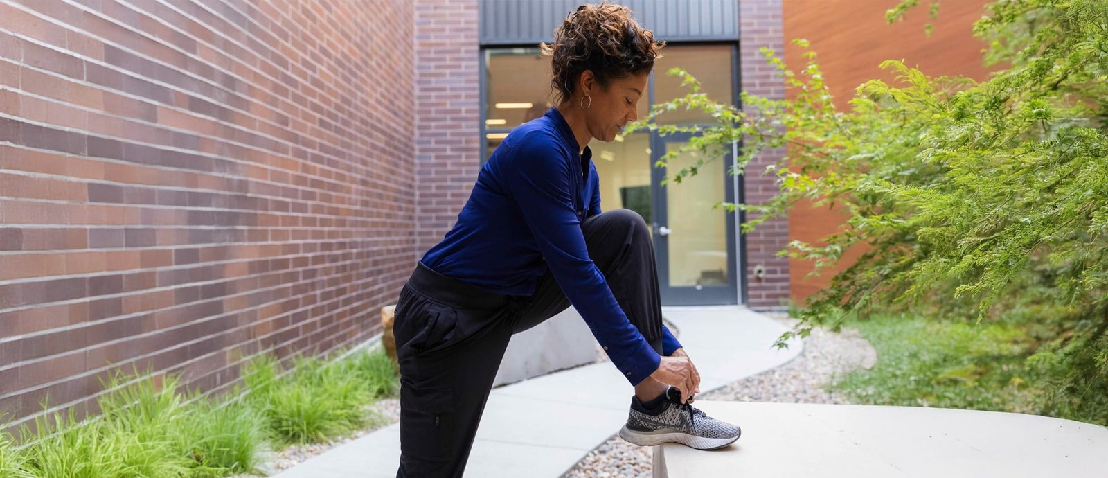 AmSAT_Image_FullWidth Woman putting on Shoe